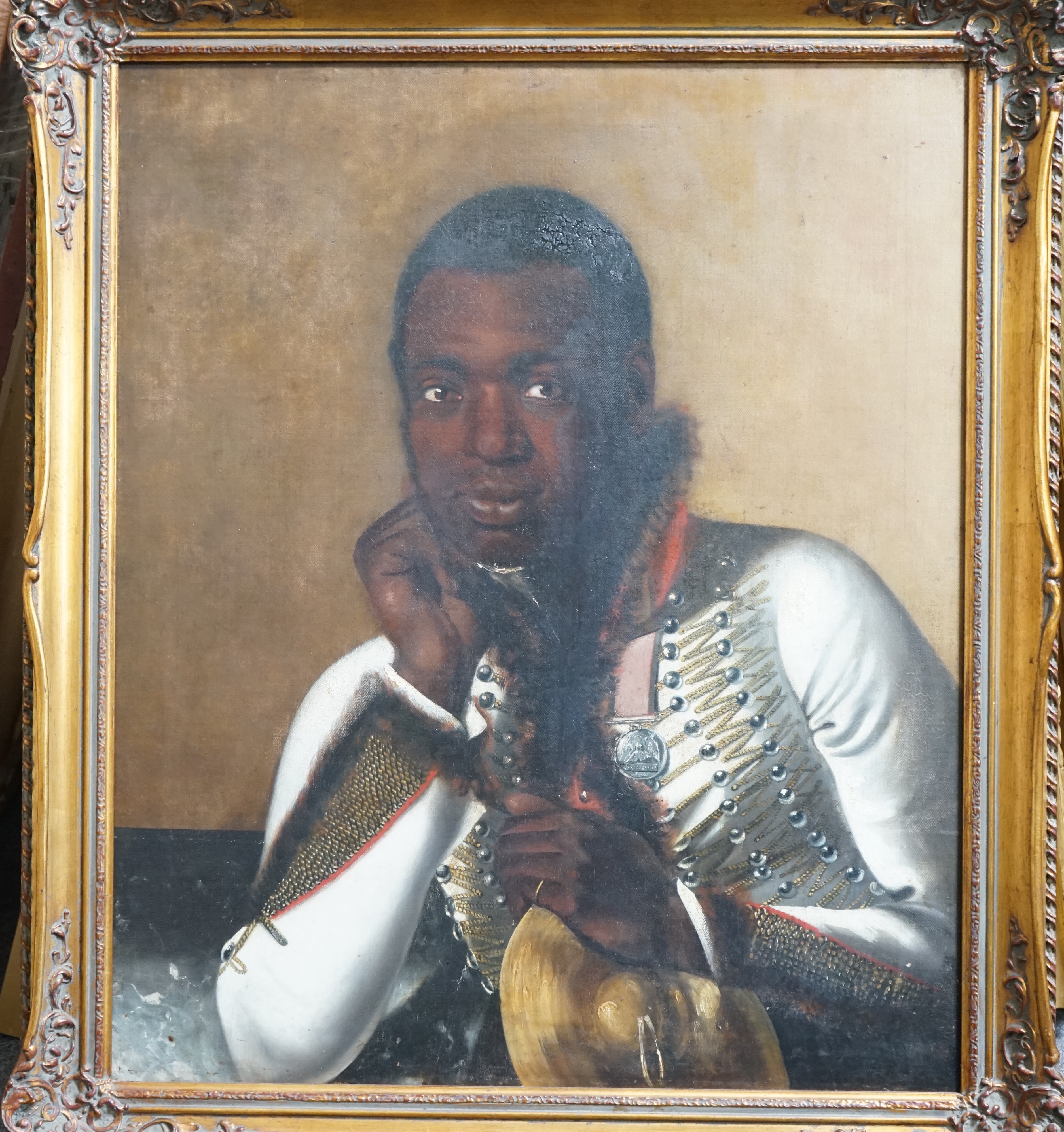 Early 19th century English School , Portrait of a black bandsman in uniform wearing the Waterloo medal and holding a cymbal, oil on canvas, 74 x 62cm